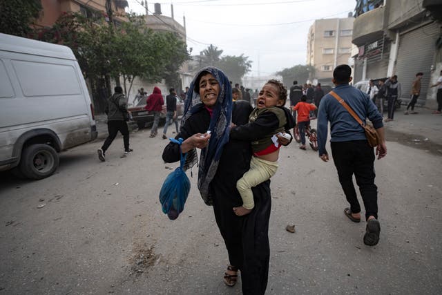 <p>Palestinians flee from a site hit by an Israeli bombardment in Rafah in the southern Gaza Strip</p>