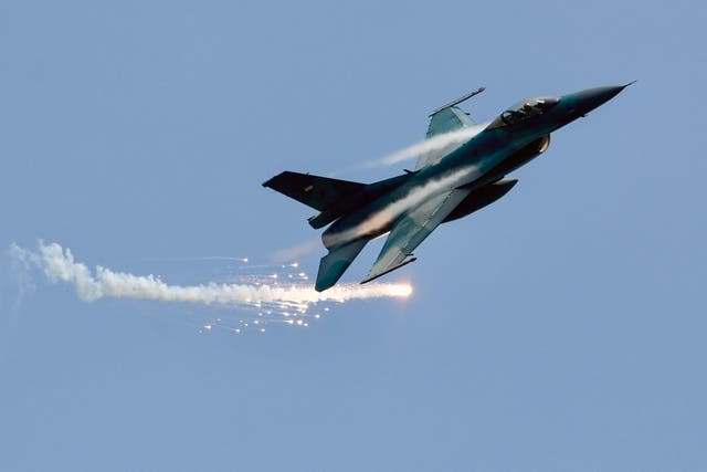 <p>FILE: A US-made F-16 fighter jet flies past while emitting flares during a rehearsal for the 78th anniversary of the Indonesian military in Jakarta </p>