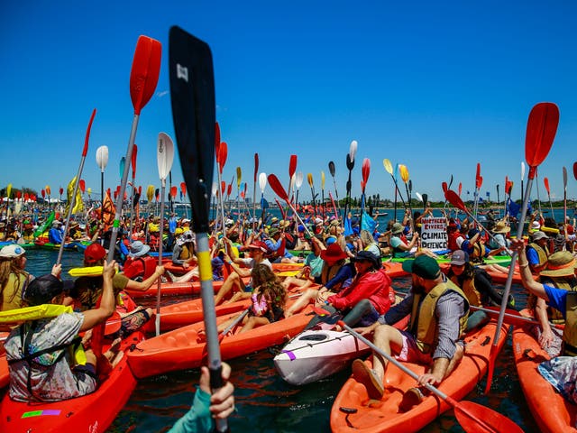 <p>People take to the water as they continue blockade the access to the coal port in protest for climate action at Horseshoe Beach on 26 November 2023 in Newcastle, Australia</p>